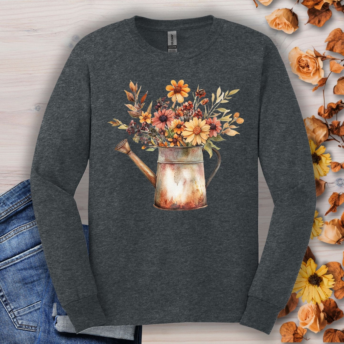 Dark Heather long sleeve tee with a watercolor rustic watering can overflowing with autumn wildflowers.