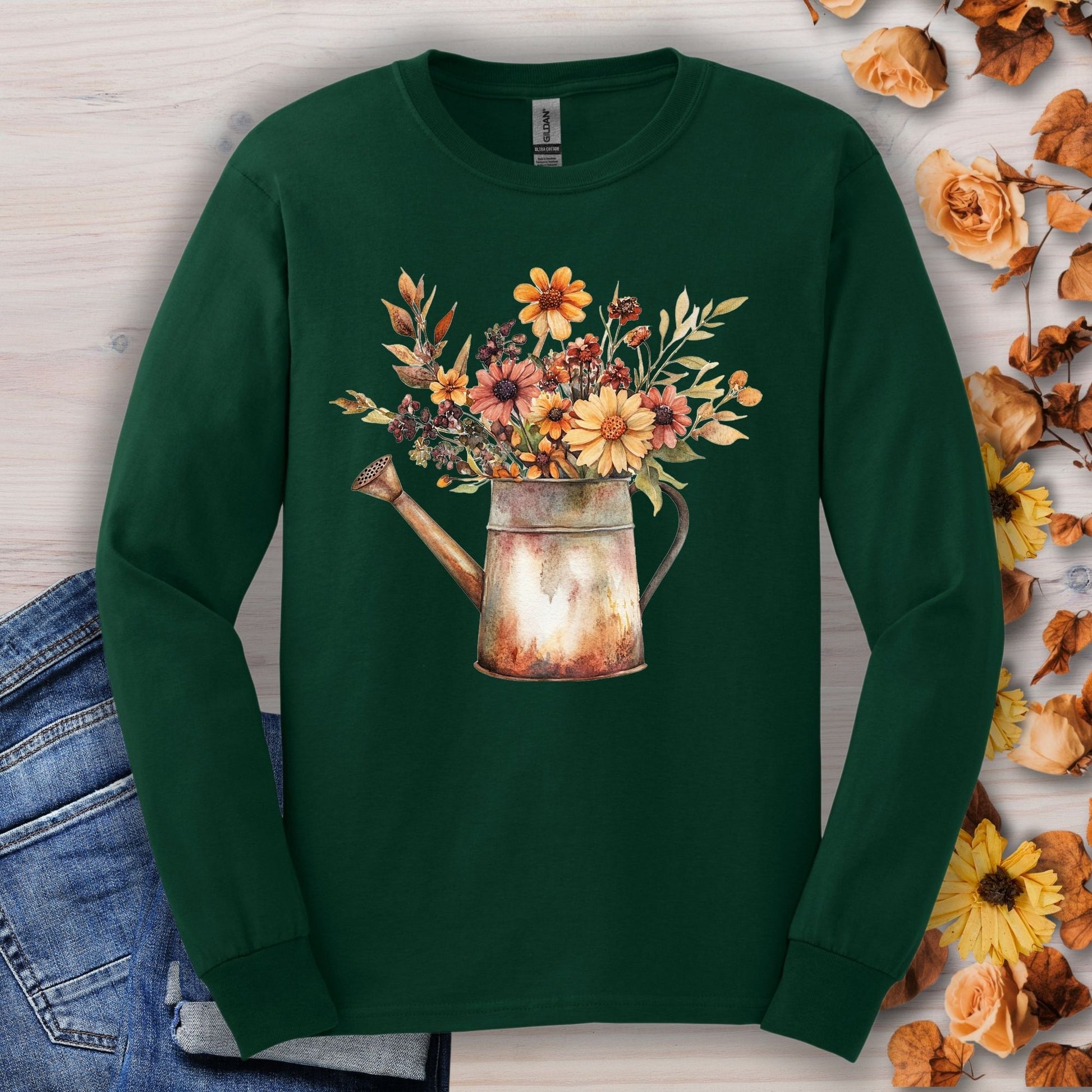 Forest Green long sleeve tee with a vintage watercolor watering can overflowing with autumn wildflowers.