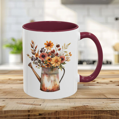 11oz ceramic mug with a maroon interior and handle, featuring a rustic watercolor watering can with autumn florals.