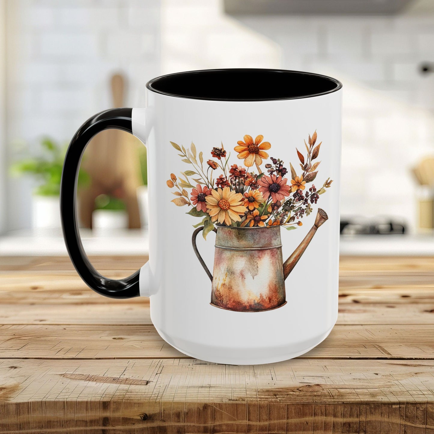 White ceramic mug with black interior and handle, featuring a rustic watercolor watering can filled with autumn florals.