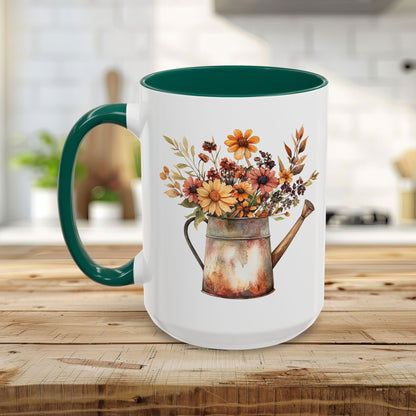 White ceramic mug with a green handle and interior, featuring a watercolor rustic autumn floral watering can design.