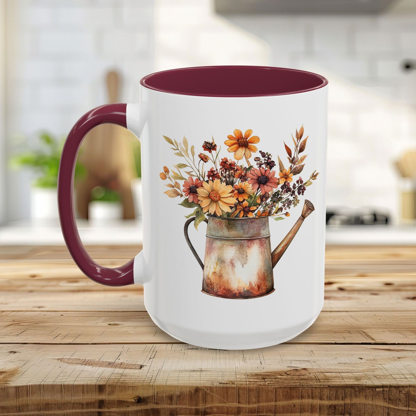 White ceramic mug with a maroon handle and interior, featuring a rustic watercolor watering can filled with autumn florals.