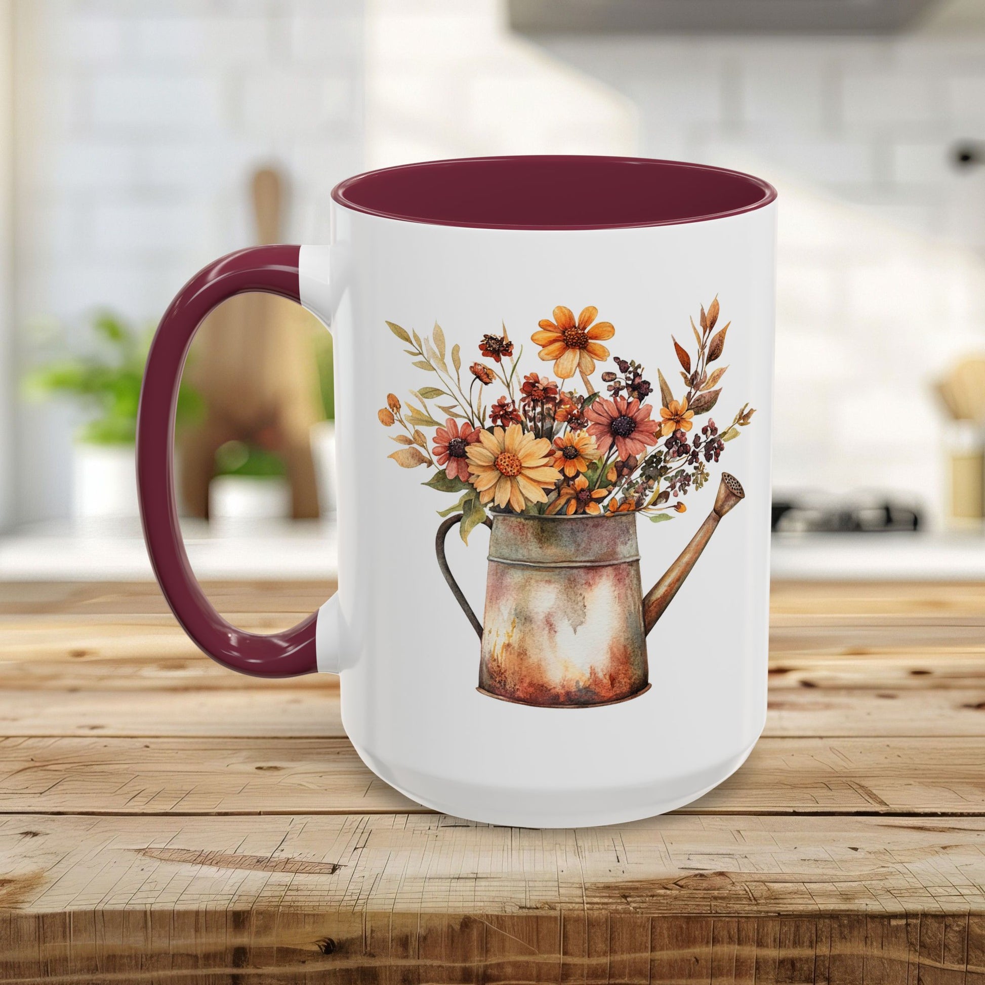 White ceramic mug with a maroon handle and interior, featuring a rustic watercolor watering can filled with autumn florals.