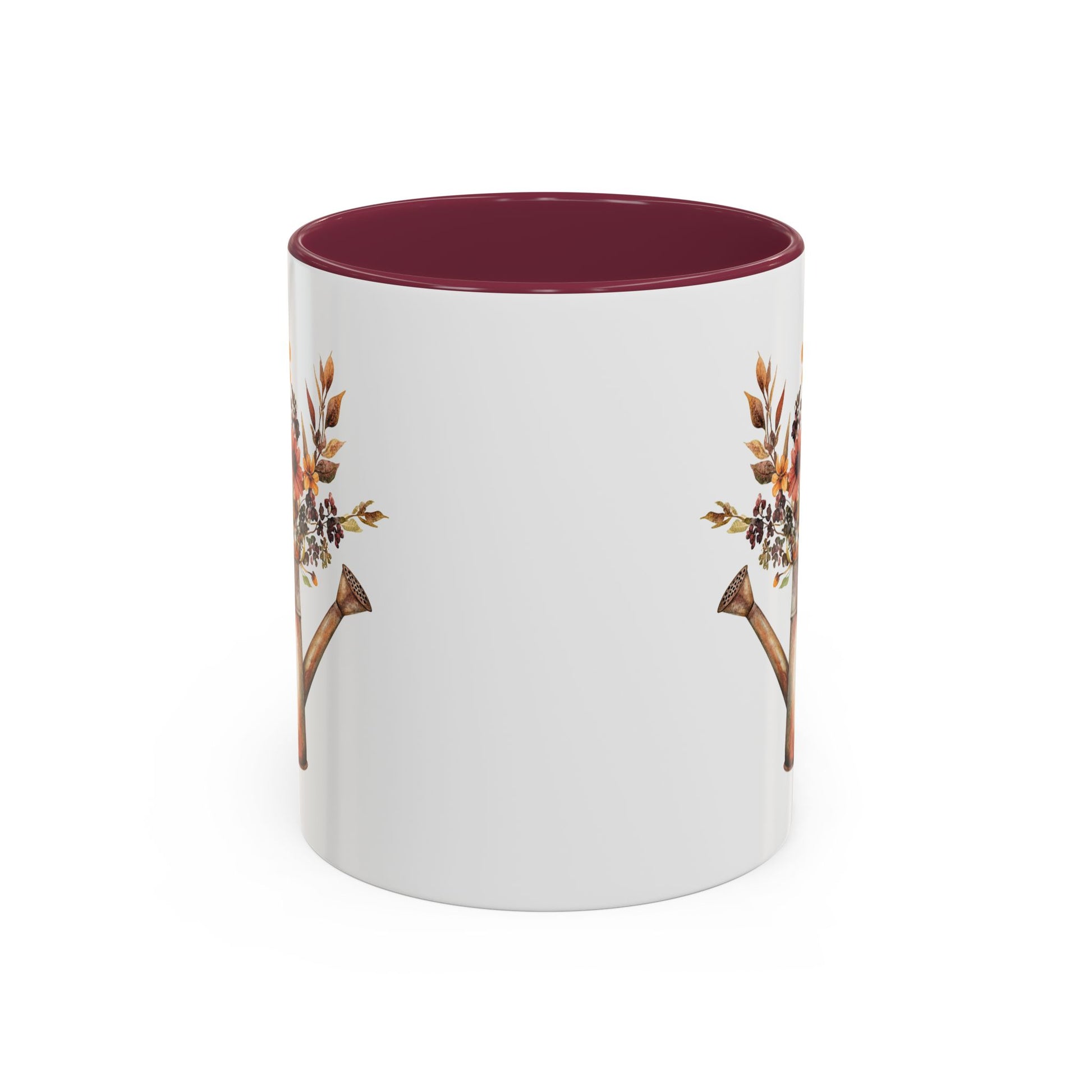 White ceramic mug with a burgundy interior and handle, featuring a rustic autumn floral watering can design.