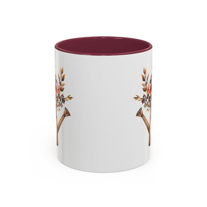 White ceramic mug with a burgundy interior and handle, featuring a rustic autumn floral watering can design.