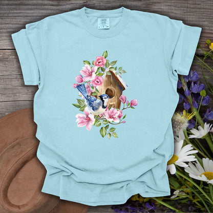 Chambray S t-shirt with a rustic birdhouse, blue jay, and pink magnolia floral watercolor design.