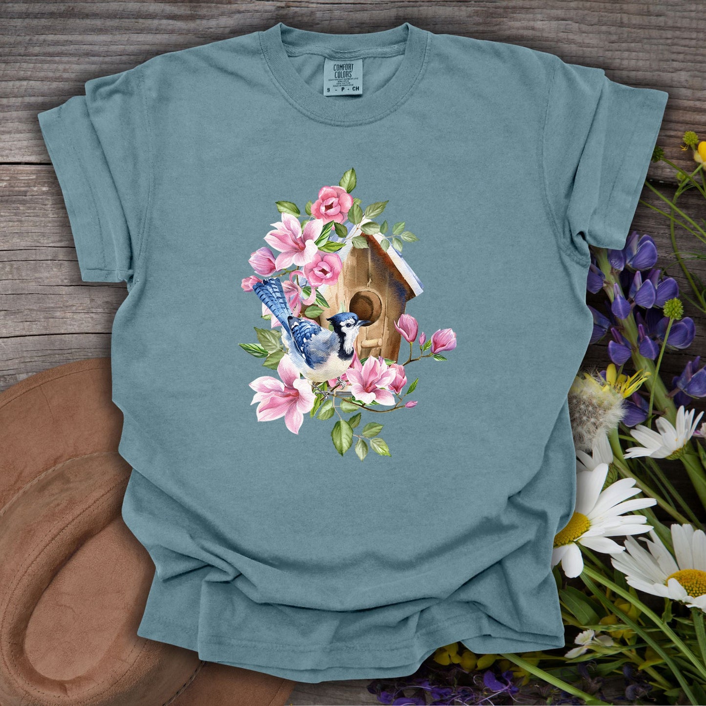 Ice Blue S t-shirt with a rustic birdhouse, blue jay, and pink magnolia watercolor design.