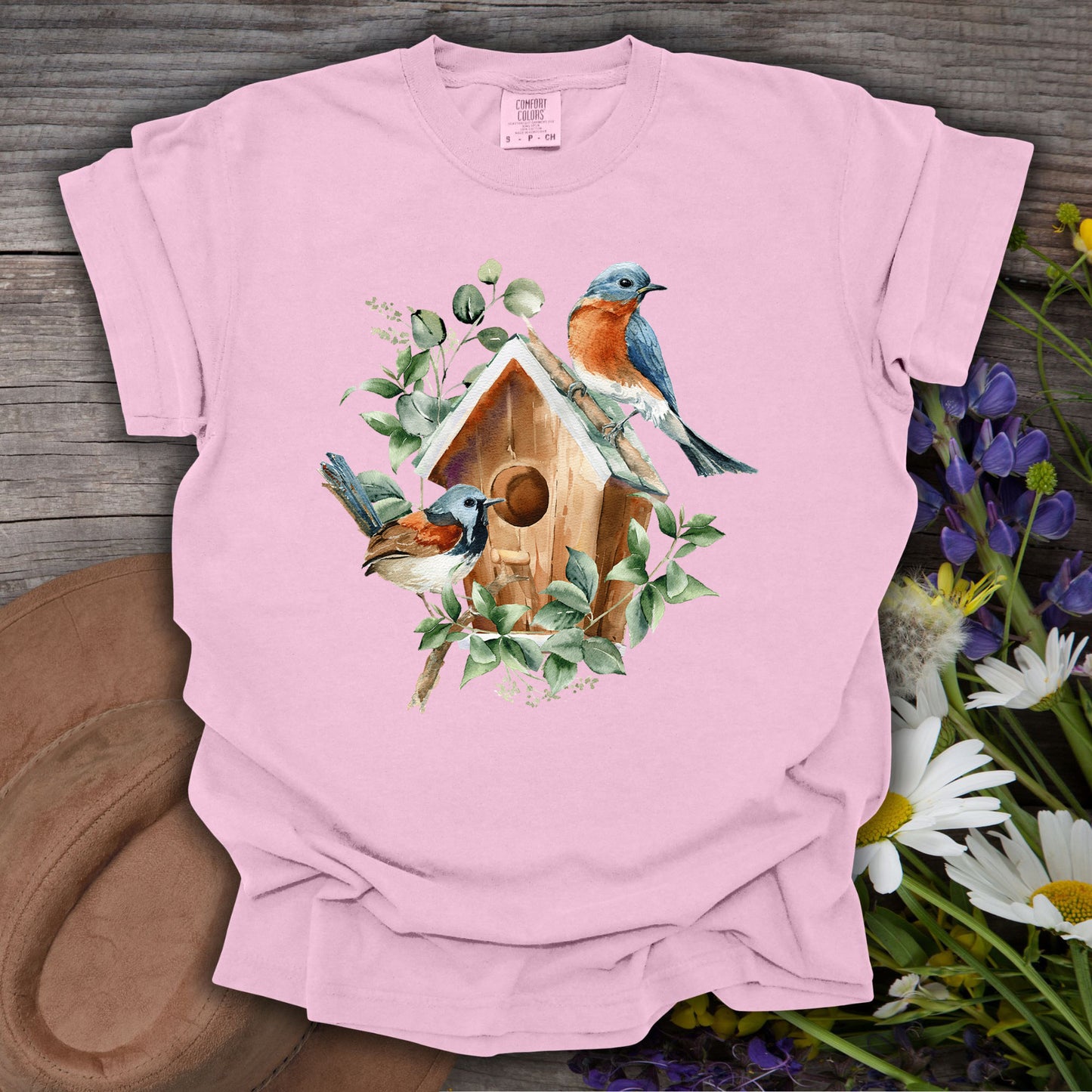 Blossom pink t-shirt with watercolor rustic birdhouse, two bluebirds, and eucalyptus foliage.