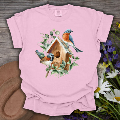 Blossom pink t-shirt with watercolor rustic birdhouse, two bluebirds, and eucalyptus foliage.