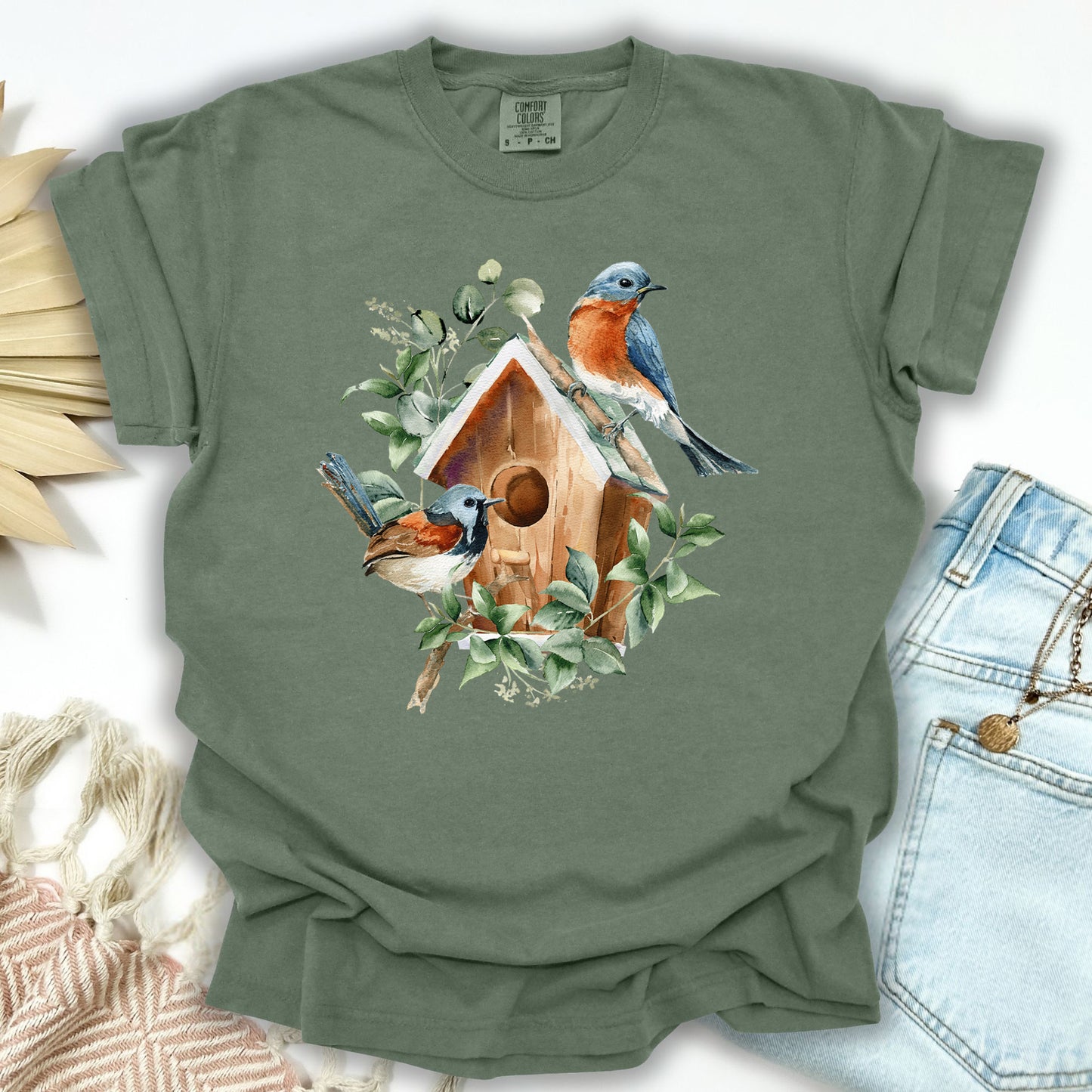 Moss S t-shirt with watercolor rustic birdhouse, bluebirds, and eucalyptus leaves.