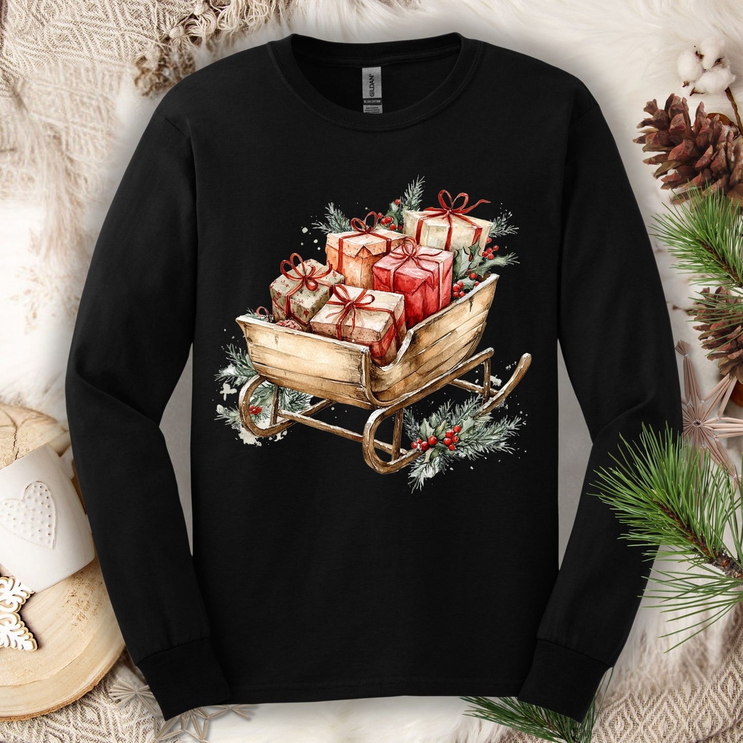 Black Gildan long sleeve tee with a watercolor rustic Christmas sleigh full of gifts and greenery.