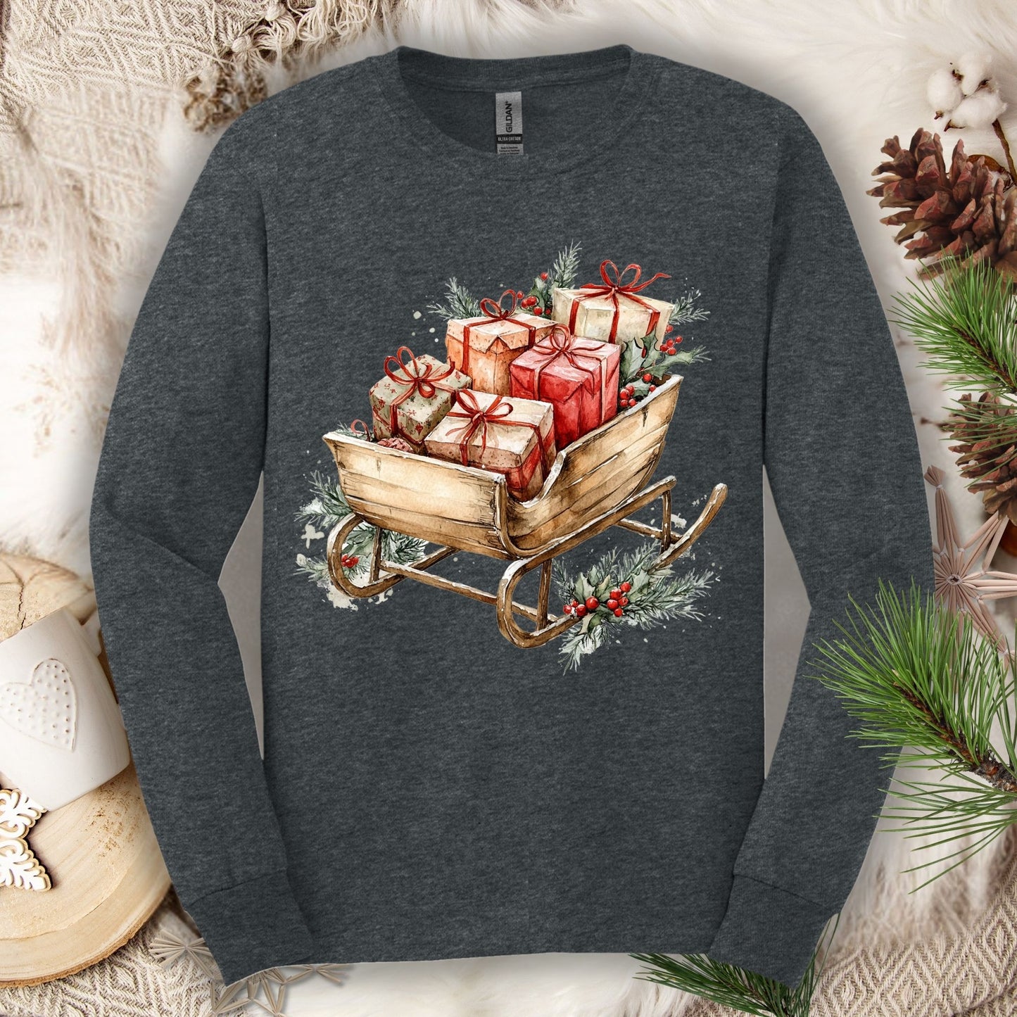 Dark Heather Gildan long sleeve tee with a rustic watercolor sleigh full of red and brown Christmas gifts.