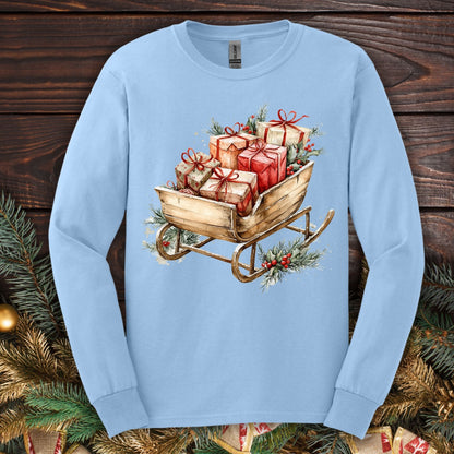 Light blue Gildan long sleeve tee with a rustic watercolor sleigh full of Christmas gifts and greenery.