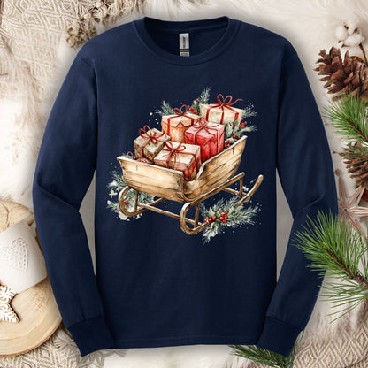 Navy long sleeve tee with a watercolor rustic Christmas sleigh brimming with gifts and greenery.