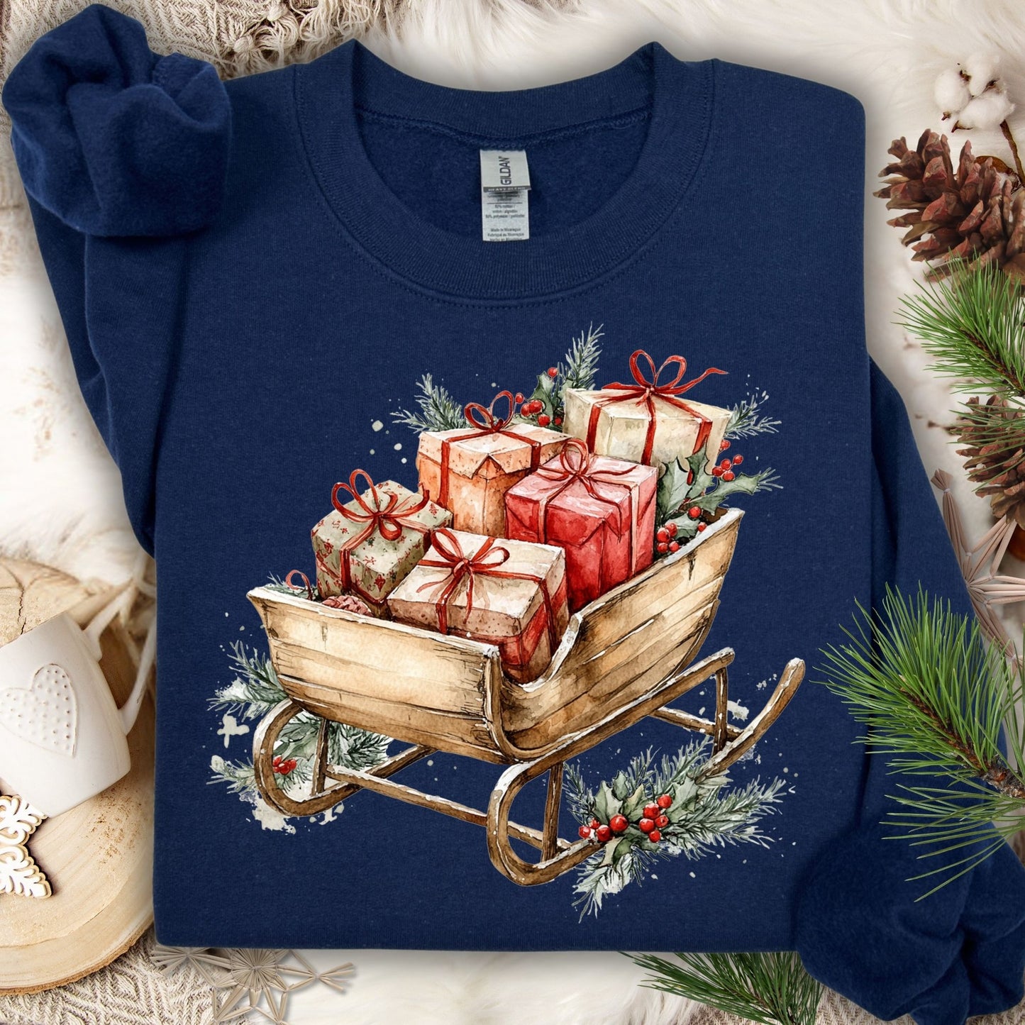 Navy Gildan fleece sweatshirt with a rustic watercolor sleigh overflowing with Christmas gifts and evergreens.