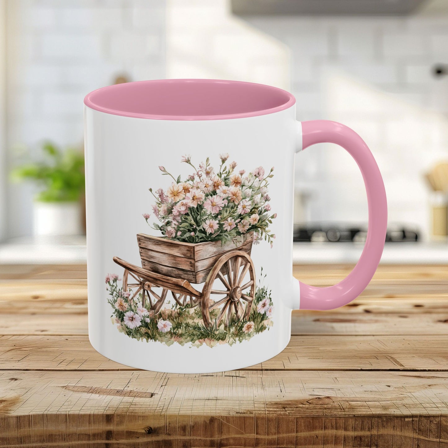 11oz ceramic mug with pink handle and interior, featuring a watercolor wheelbarrow overflowing with pink blooms.