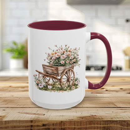 15oz white ceramic mug with maroon interior/handle and a watercolor wheelbarrow of pink blooms.