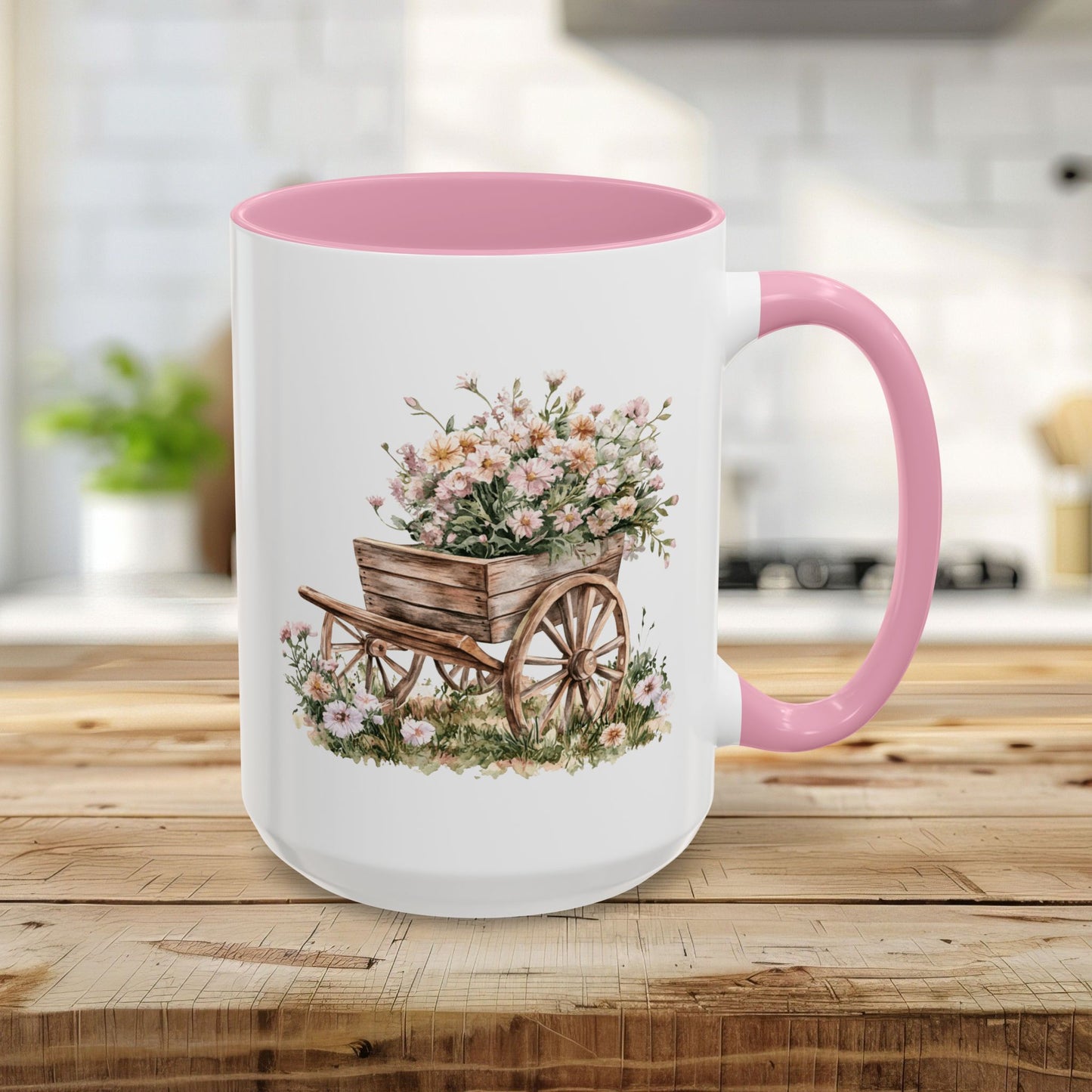 15oz white ceramic mug with pink interior/handle, featuring a watercolor wheelbarrow overflowing with pink blooms.