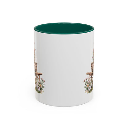 White ceramic mug with green interior and handle, featuring a watercolor wheelbarrow with pink blooms.