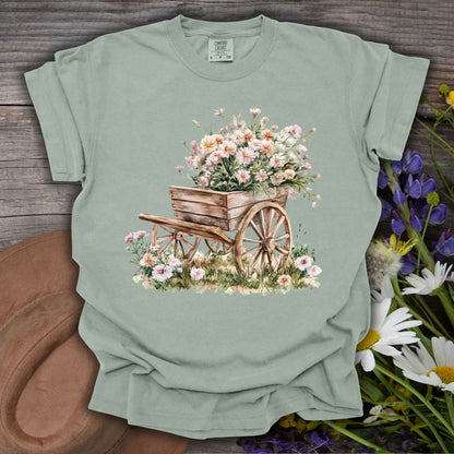 Bay S-sized t-shirt with a rustic wooden garden wagon overflowing with delicate pink and white flowers.
