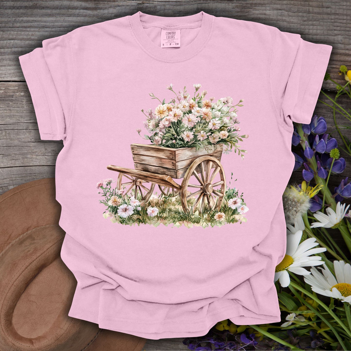 Blossom pink S t-shirt with a vintage botanical illustration of a rustic wooden wagon overflowing with delicate flowers.