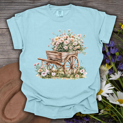 Chambray S t-shirt with a rustic wooden wagon overflowing with pink and white flowers.
