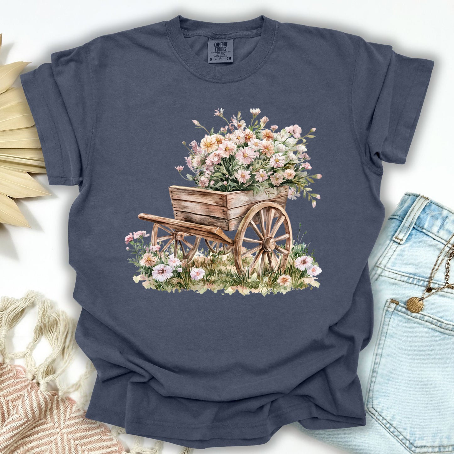 Denim S t-shirt with a rustic wooden wagon overflowing with delicate pink and white flowers.