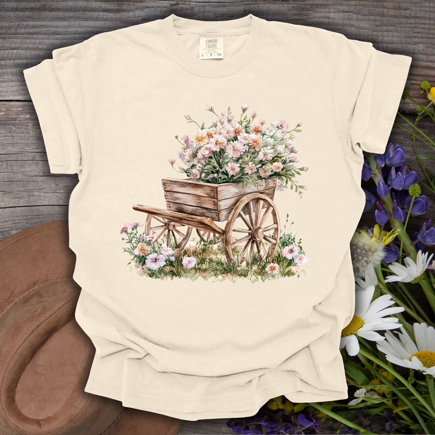 Ivory S t-shirt with a vintage botanical illustration of a rustic wooden wagon overflowing with delicate flowers.