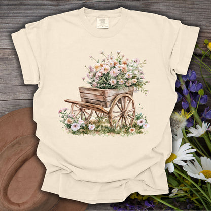 Ivory S t-shirt with a vintage botanical illustration of a rustic wooden wagon overflowing with delicate flowers.