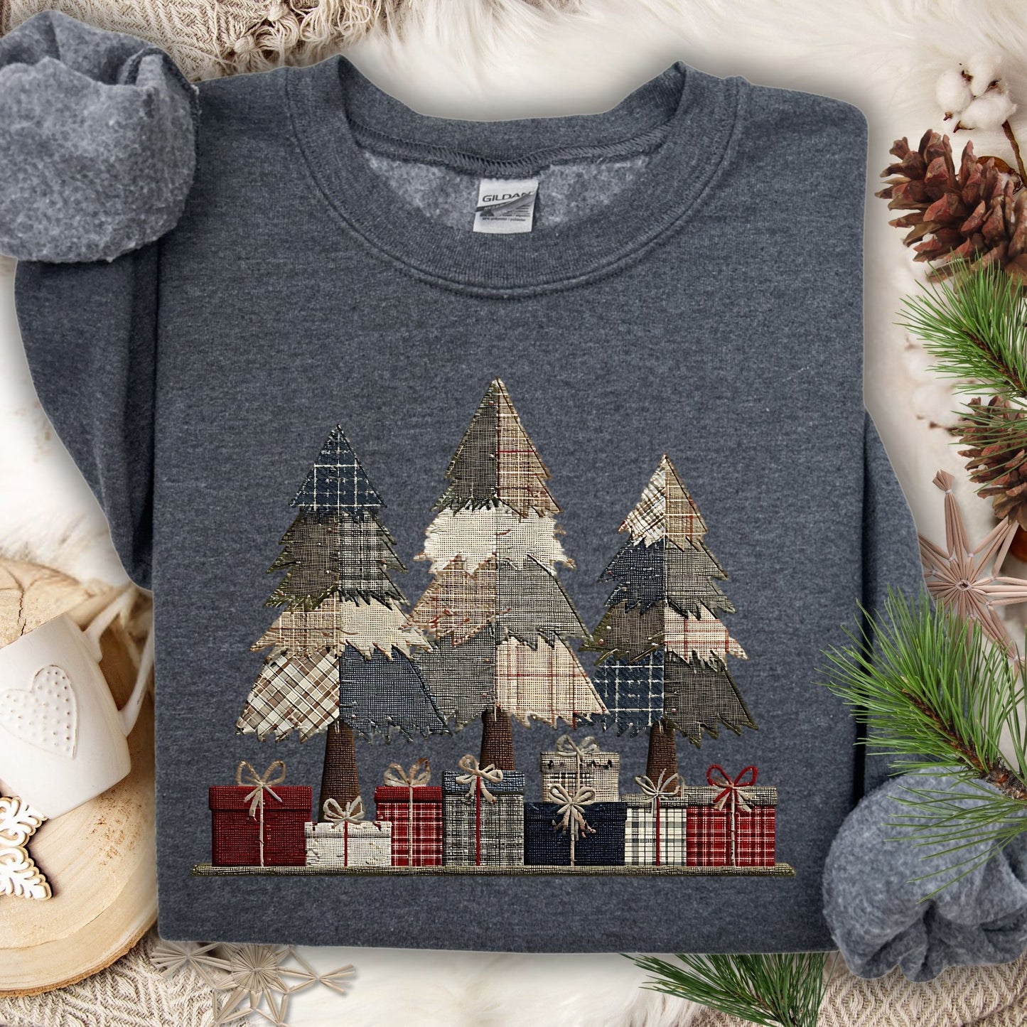 Dark Heather Gildan sweatshirt with a faux patchwork design of rustic Christmas trees and gifts.
