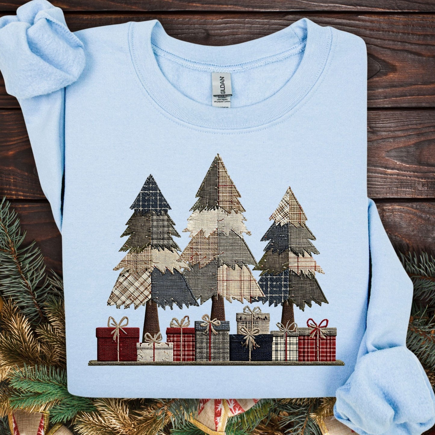 Light blue Gildan sweatshirt with faux patchwork rustic Christmas trees and gifts.
