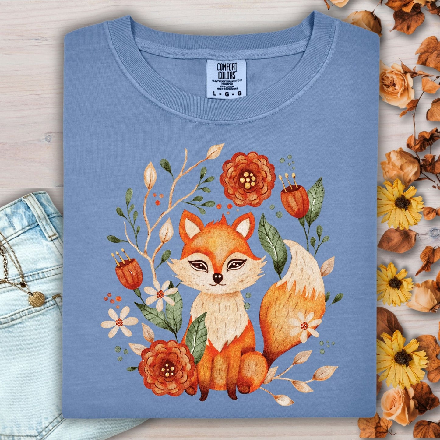 Blue Jean Rustic Folk Art Fox Tee, folded, with a watercolor fox and floral design.