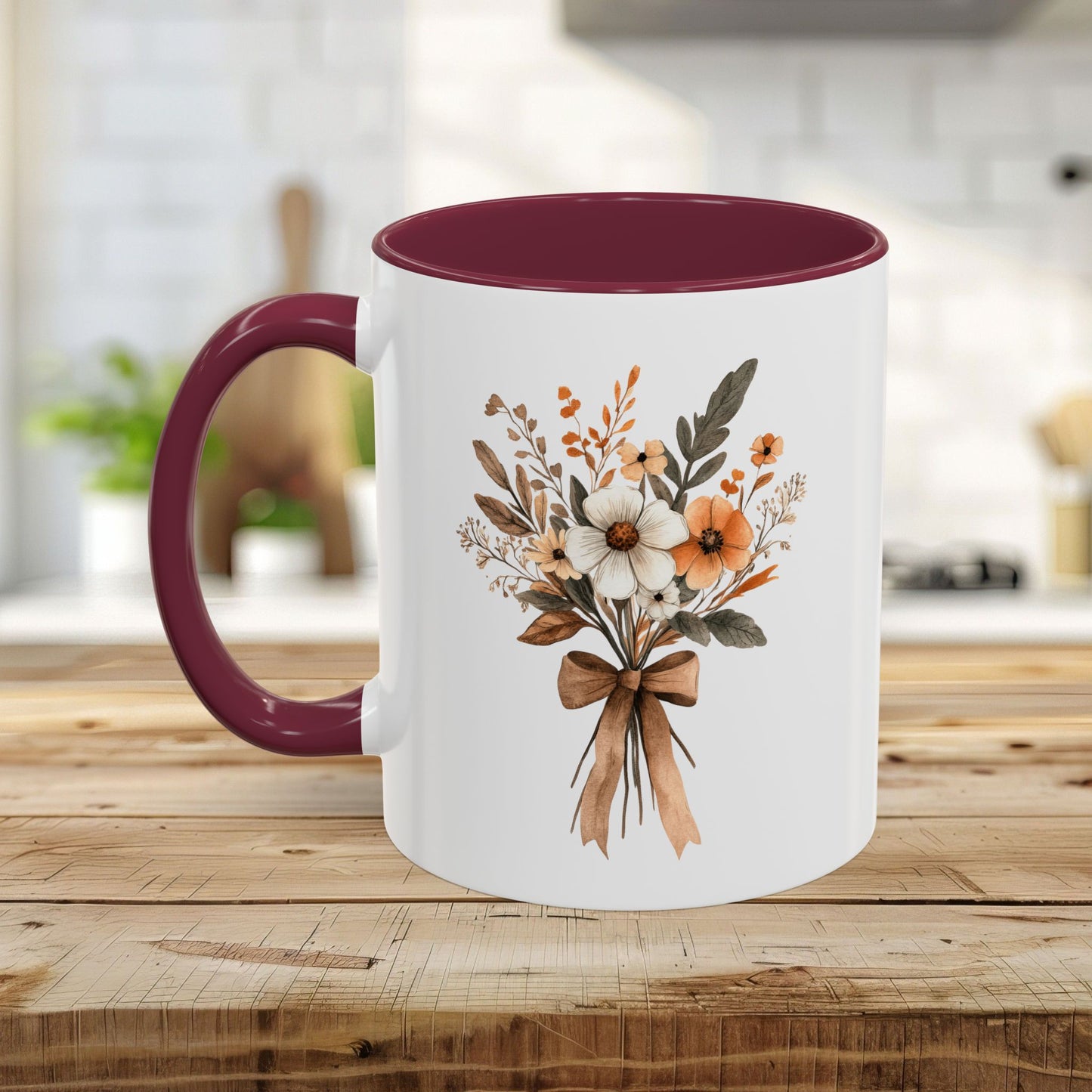 White ceramic mug with a sepia and cream floral bouquet, burgundy interior, and handle.