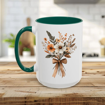 White ceramic mug with a green interior and handle, featuring a sepia and cream floral bouquet design.