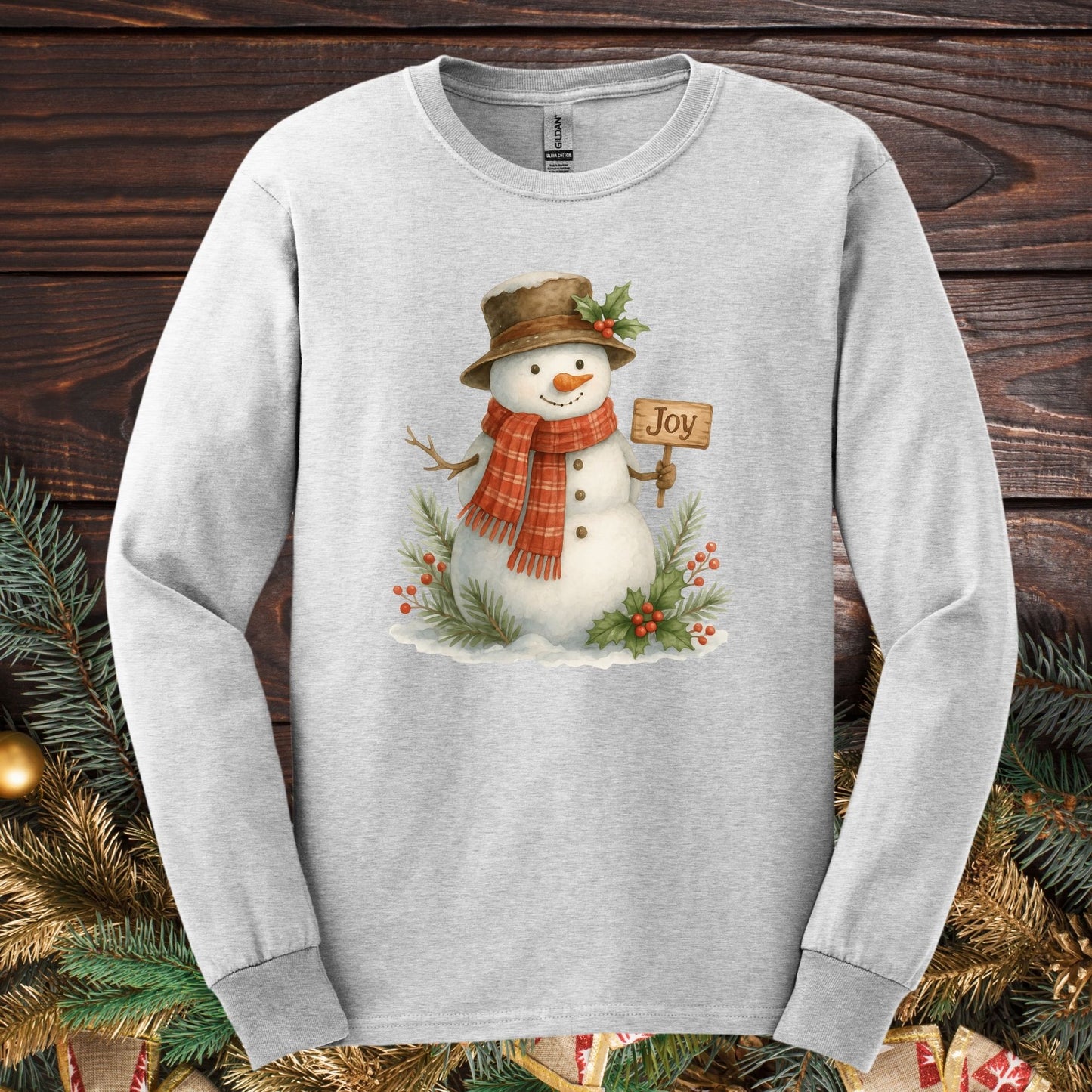 Ash Gildan 2400 long sleeve tee with a watercolor snowman holding a "Joy" sign.