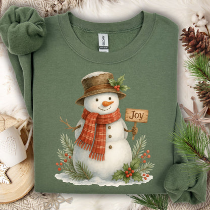 Military Green Gildan 18000 sweatshirt with a watercolor snowman holding a "Joy" sign, surrounded by holly.