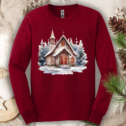 Cardinal Red Gildan long sleeve tee with a rustic chapel and snowy evergreens.