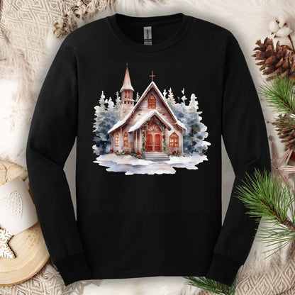 Black Gildan long sleeve tee with a rustic chapel in snow, holly, and pine garland.