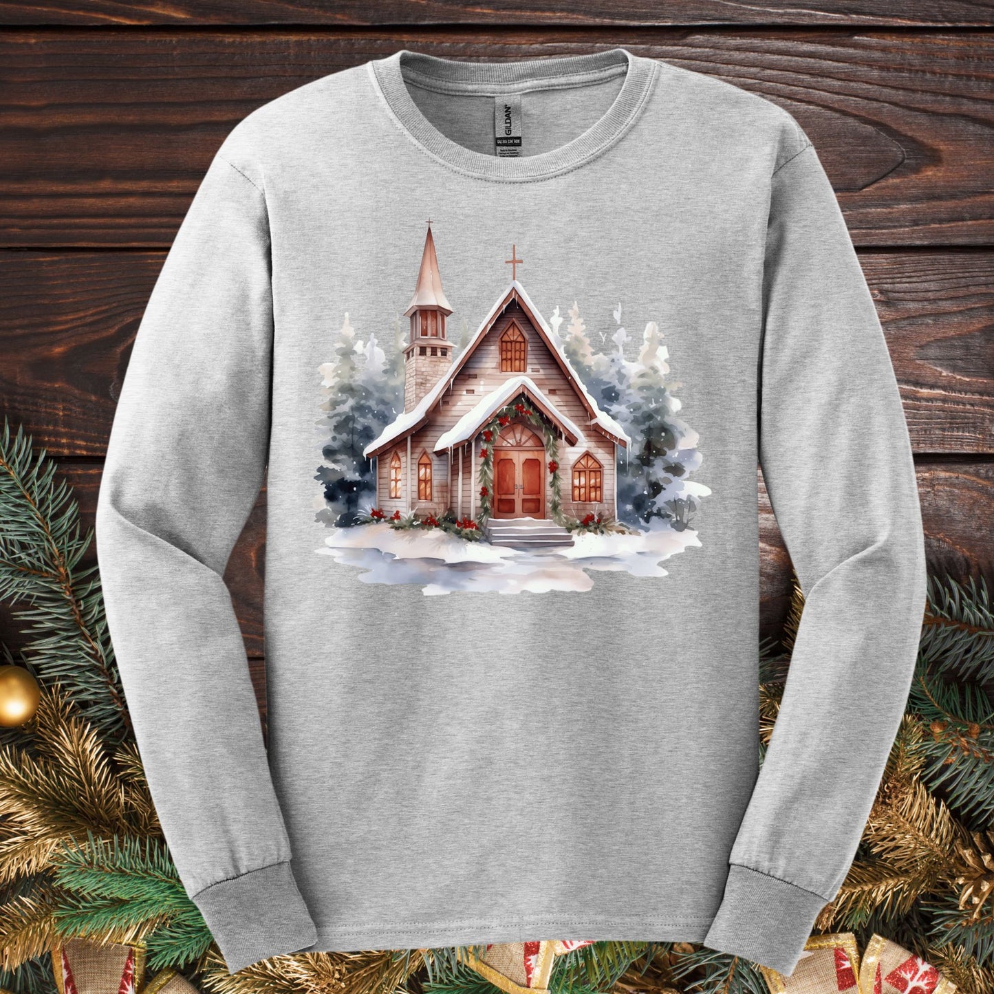 Ash gray Gildan long sleeve tee with a rustic snow-dusted chapel and evergreens design.