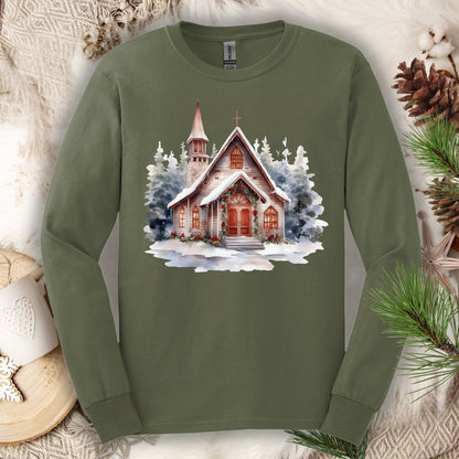 Military Green long sleeve tee with a rustic chapel, evergreens, snow, holly, and pine garland design.