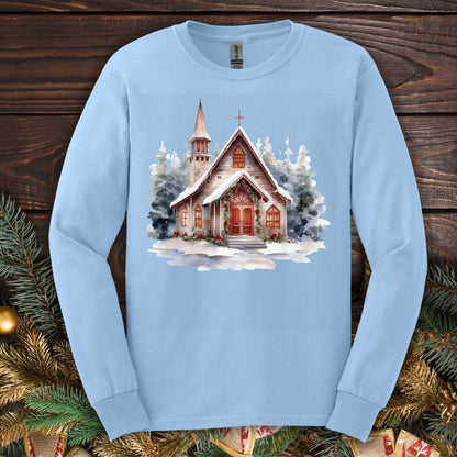 Light blue Gildan long sleeve tee with a rustic snow-covered chapel, evergreens, and holly garland.