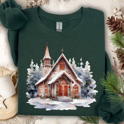Forest Green Gildan sweatshirt with a watercolor rustic chapel in snow, adorned with Christmas greenery.