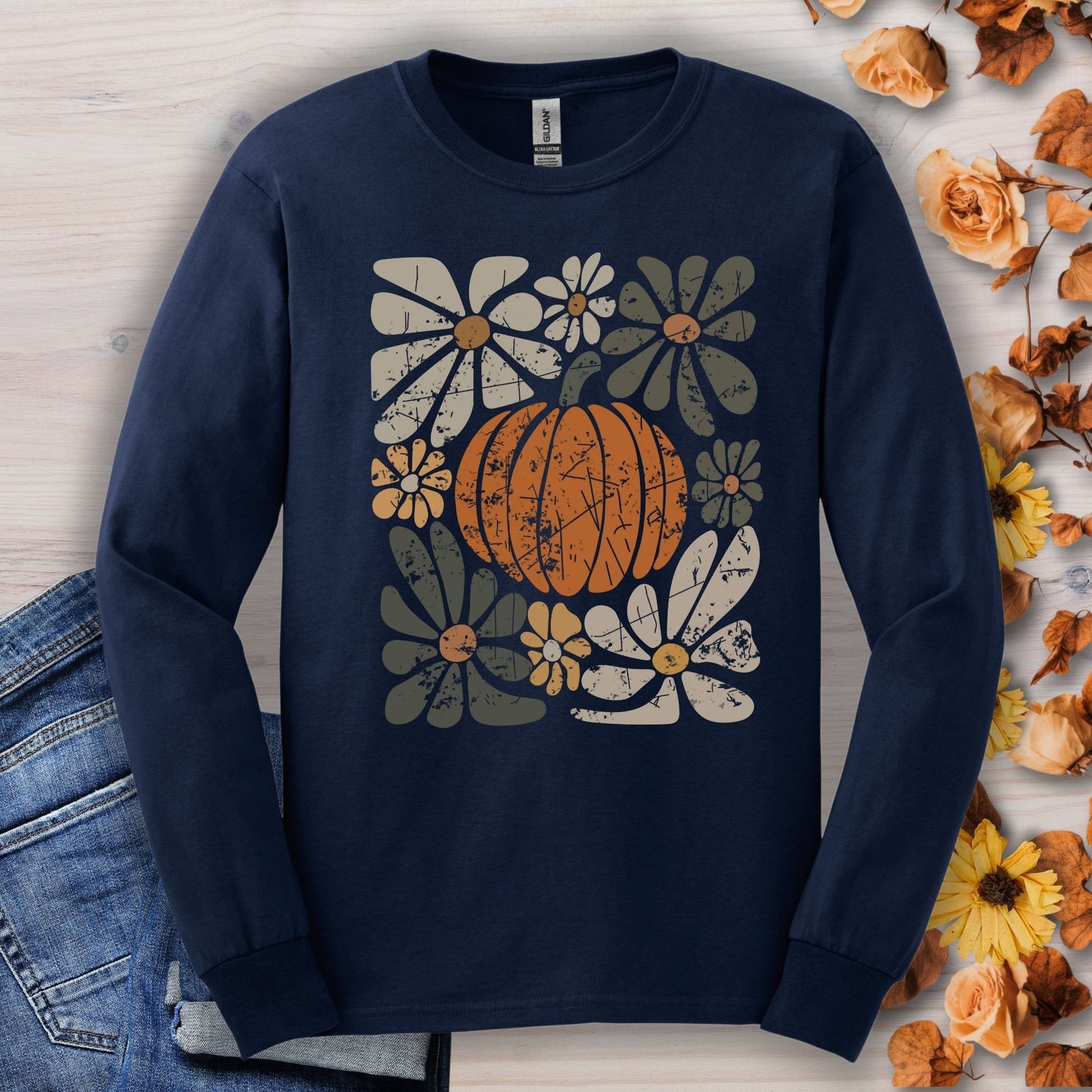 Navy long sleeve tee with a rustic pumpkin and muted floral design, 100% cotton, unisex fit.