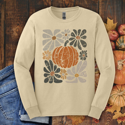 Sand Gildan 2400 long sleeve tee with a rustic pumpkin and muted floral design, surrounded by fall leaves.