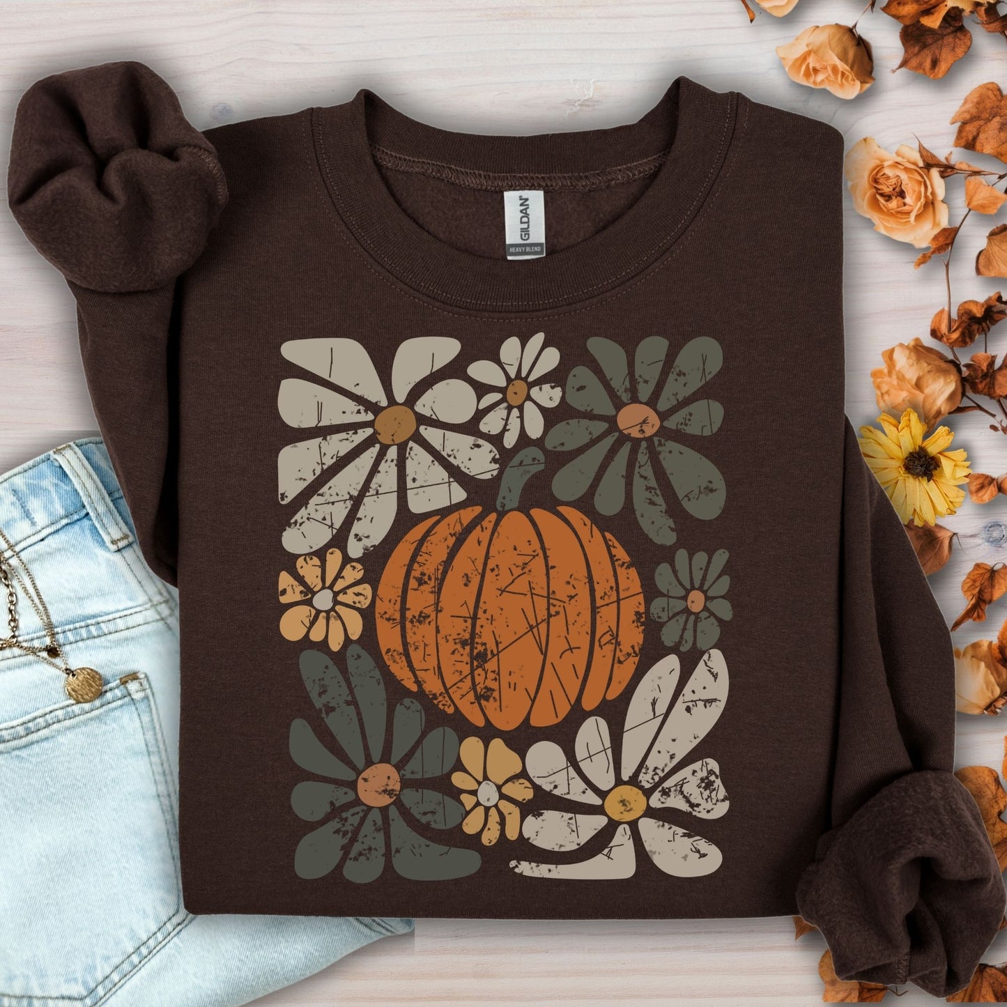 Dark chocolate garment-dyed cotton sweatshirt with a rustic orange pumpkin and retro floral design.