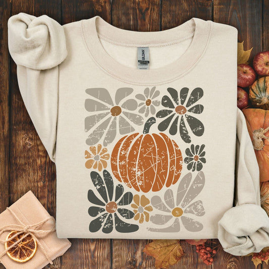 Sand garment-dyed cotton sweatshirt with a rustic orange pumpkin and retro floral design.