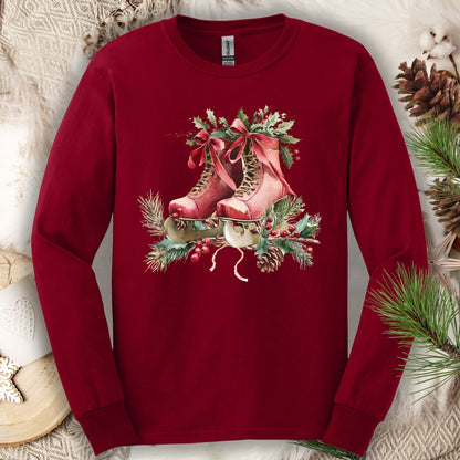 Cardinal Red long sleeve tee with a watercolor design of rustic red ice skates, holly, and evergreens.