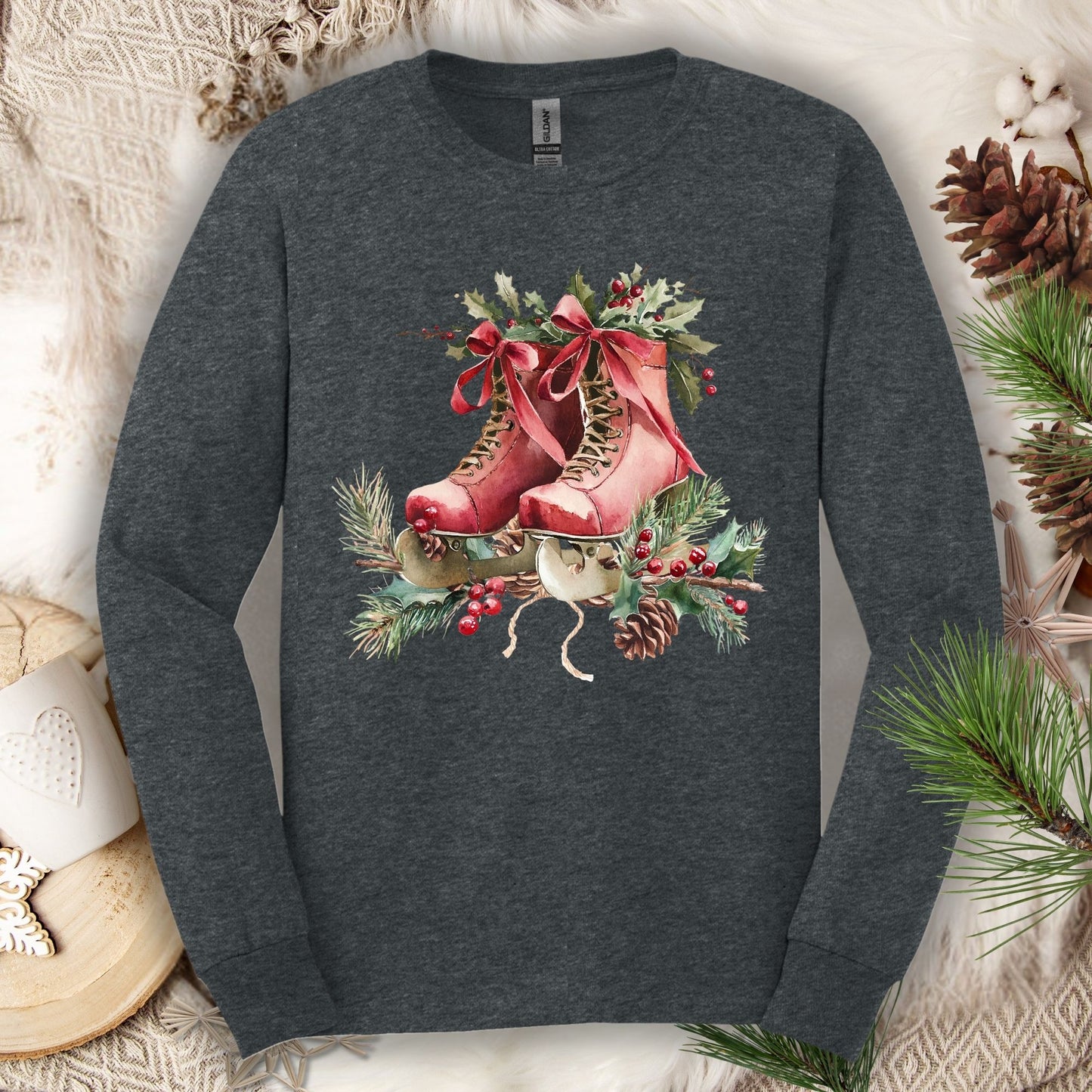 Dark Heather S long sleeve tee with watercolor red ice skates, holly, and evergreens.