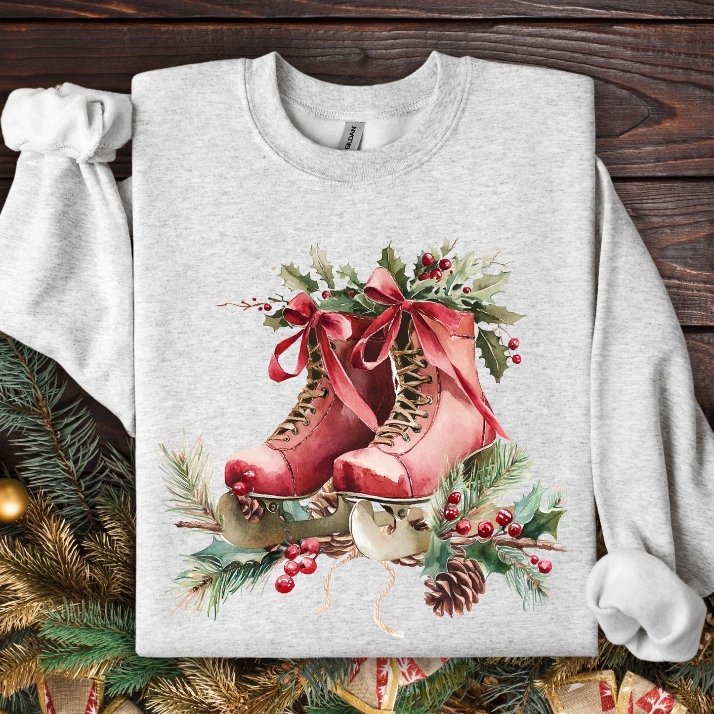 Ash grey sweatshirt with rustic red watercolor ice skates, holly, and pine needles.