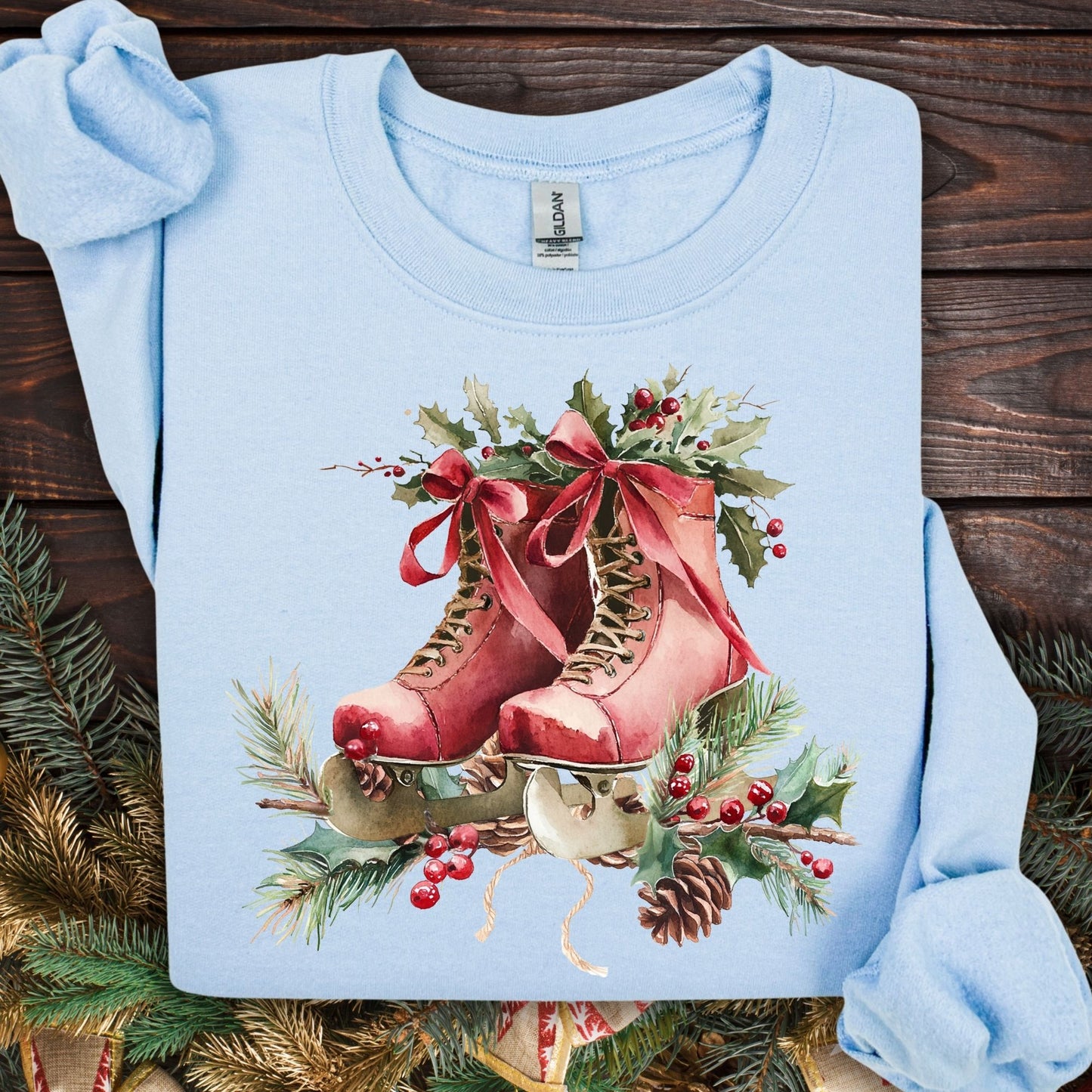 Light blue S sweatshirt with rustic red watercolor ice skates, holly, and pine needles.